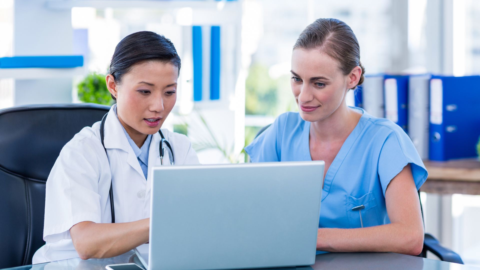 Asian nurse working on laptop